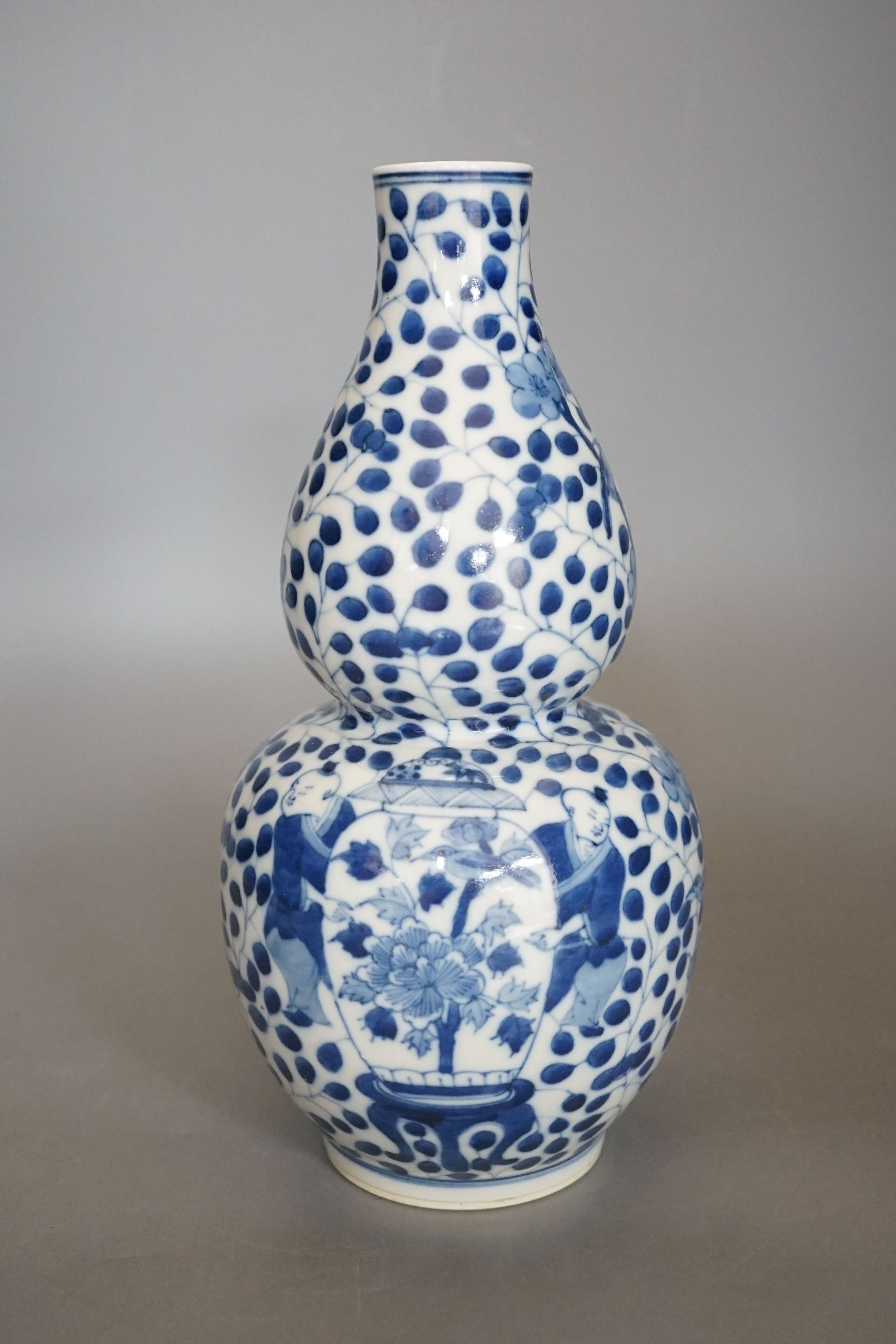 A Chinese double gourd blue and white vase, 27 cms high.